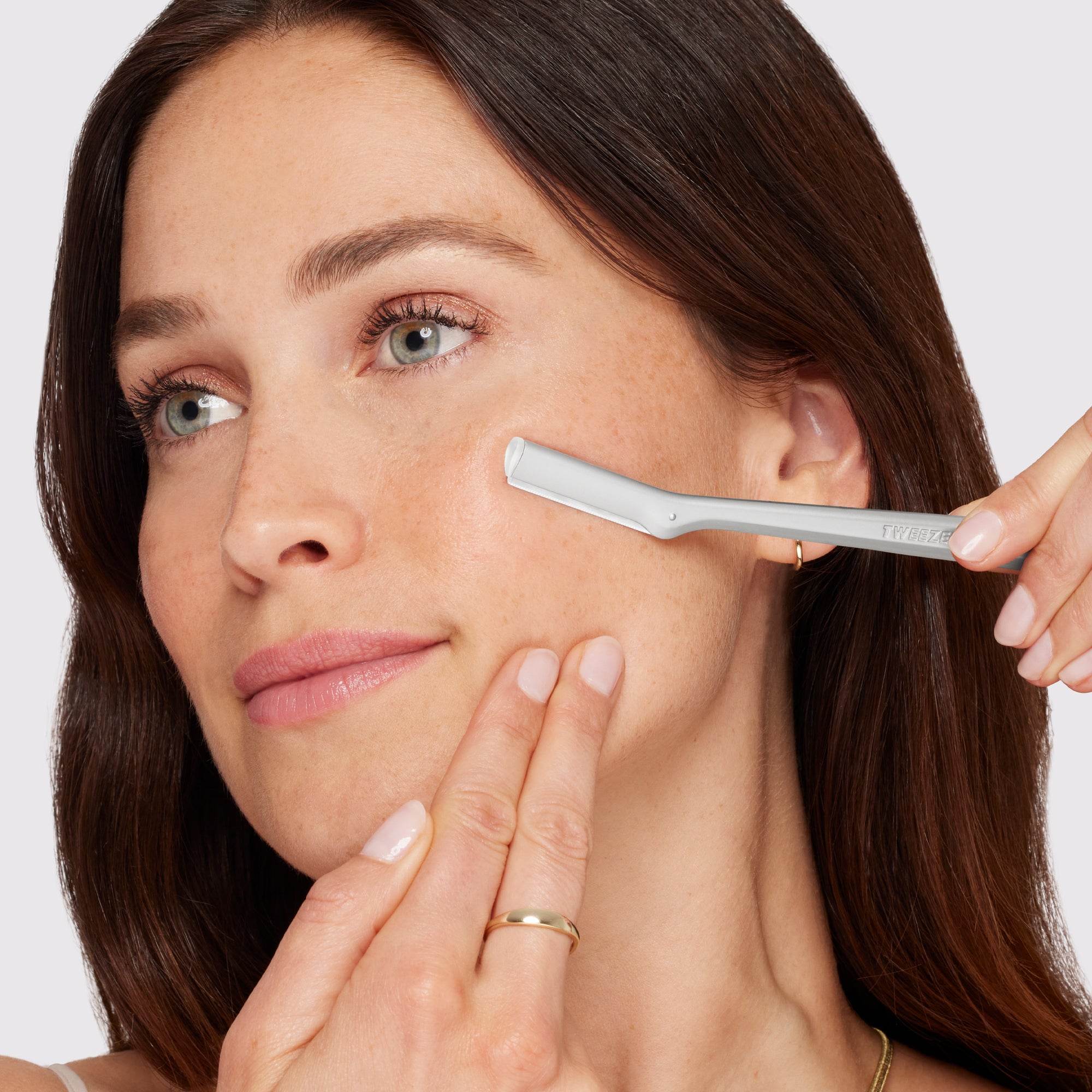 Model using Facial Razor. Shop New Beauty Collection.