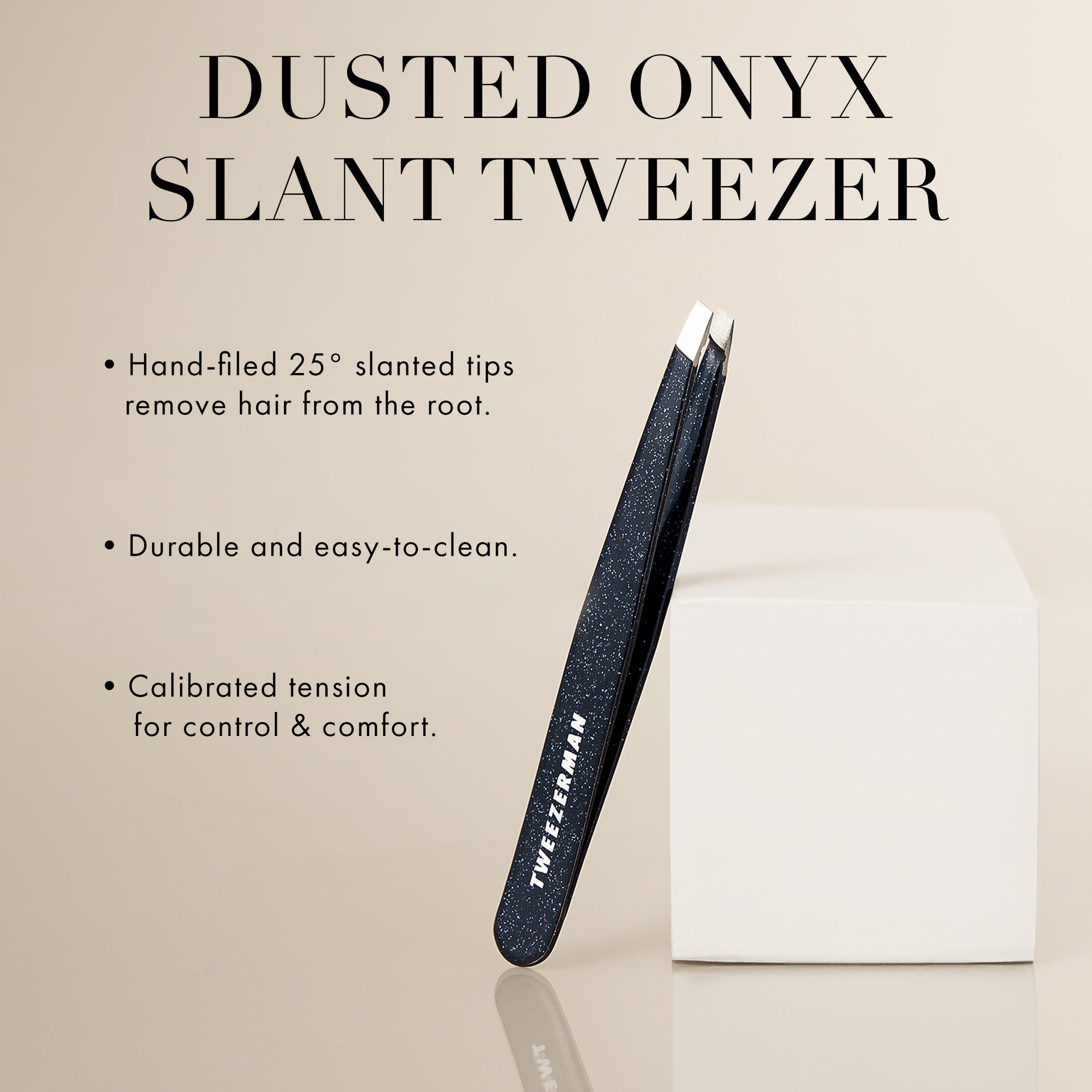 Dusted Onyx slant tweezer with product details on a beige background. Hand filed 25 degrees slanted tips remove hair from the root. Durable and easy to clean. Calibrated tension for control &amp; comfort.