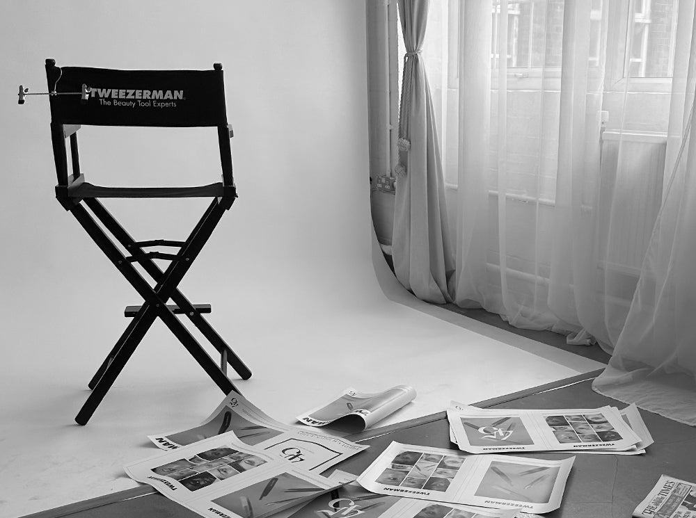 Tweezerman high chair with magazines on the floor next to it