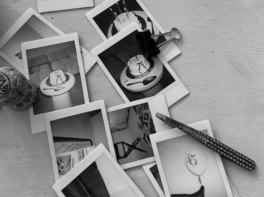 Black and white printed photos and a tweezer on top of them