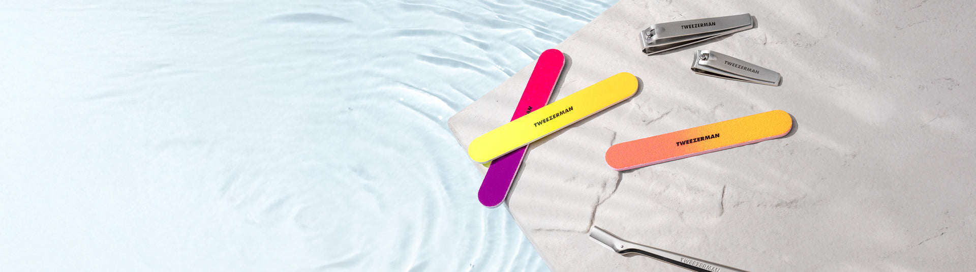 The Neon Kit Manicure Set on the side of a Pool