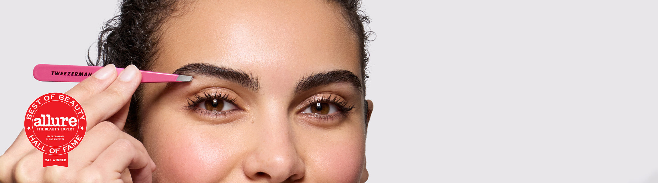 Model image using a pink tweezer and the allure winner badge