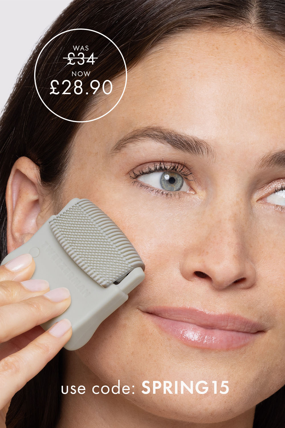 Woman using the cleansing top from the 3-in-1 Facial Roller tool on her face and a was price of £34, and now £28.90. Use code SPRING15