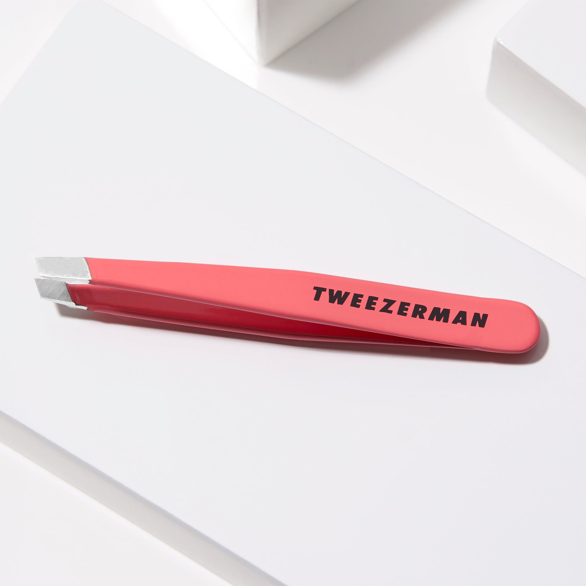 Mini Geranium Slant  Tweezer on a white block