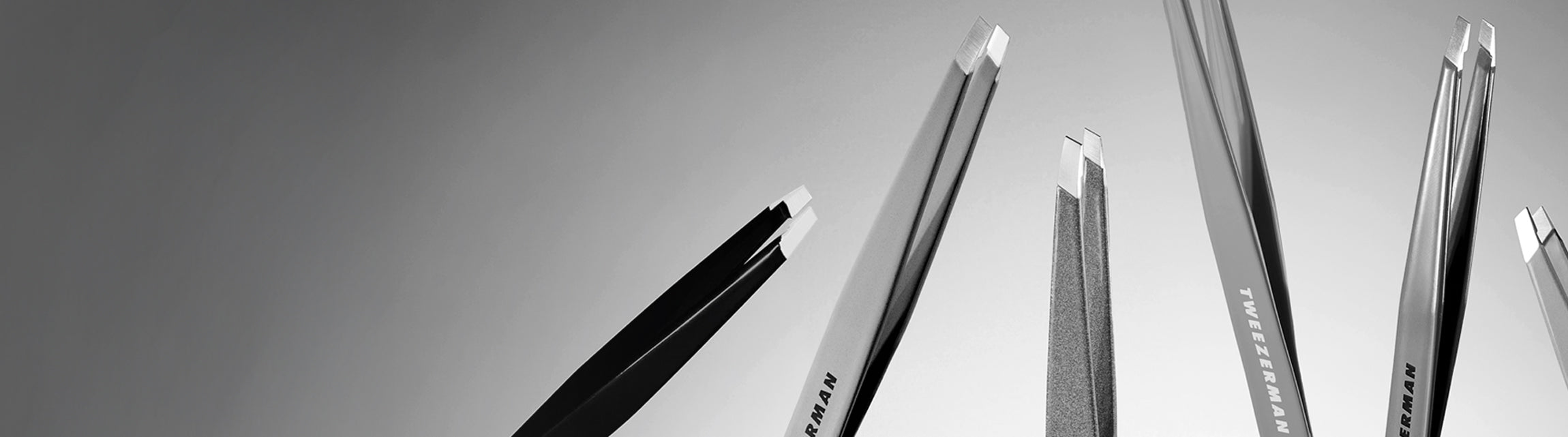 Black and White tweezers on a plain background