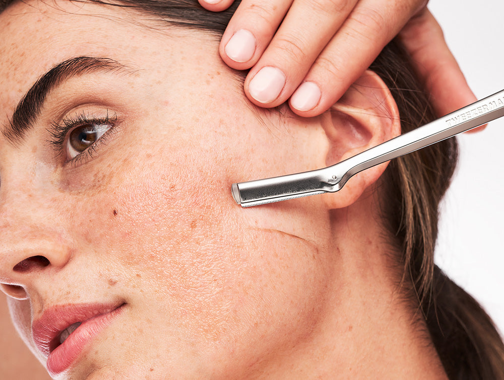 Model using the Facial Razor to clear peach fuzz