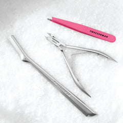 Facial Razor, Nipper and Pink Tweezer on a snow background