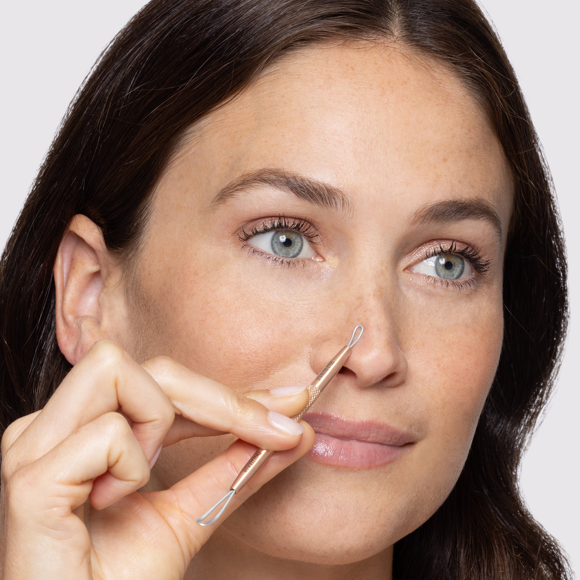 MODEL USING Rose Gold No-Slip Skincare Tool on nose