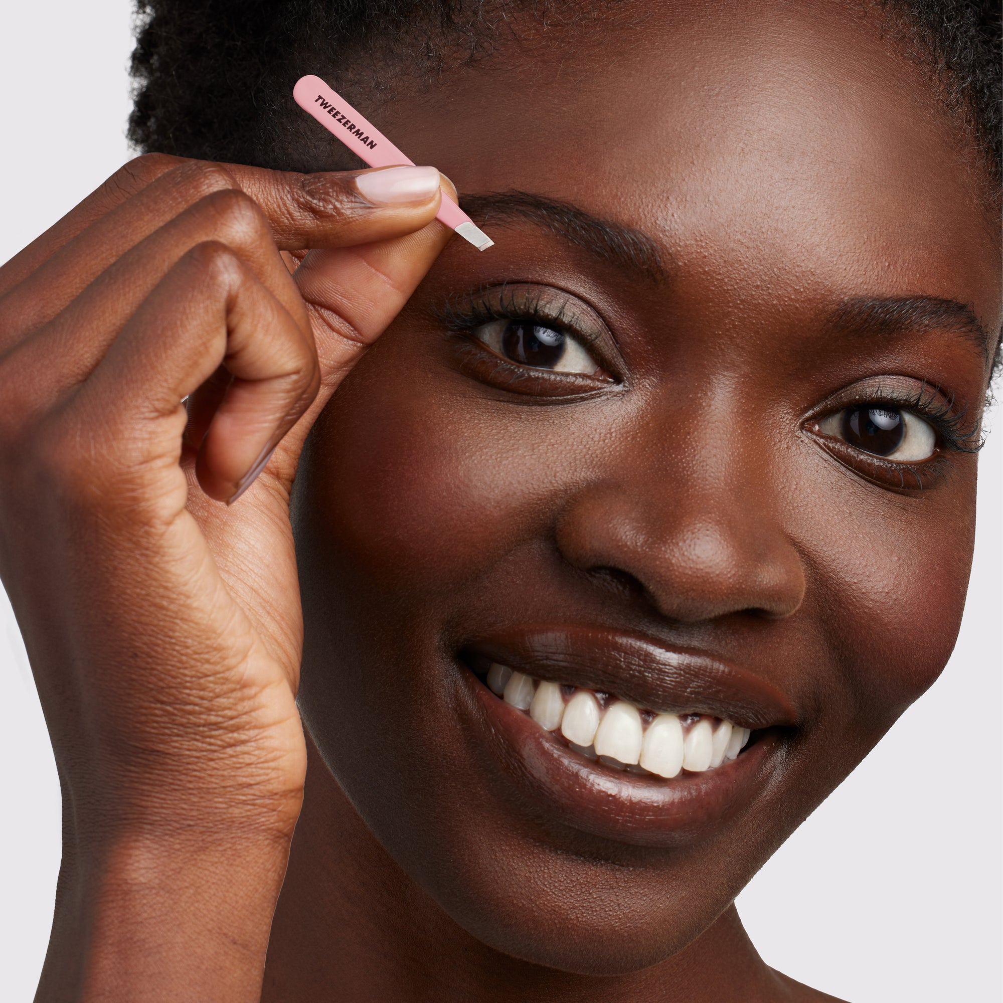 Model using pink micro mini slant tweezer