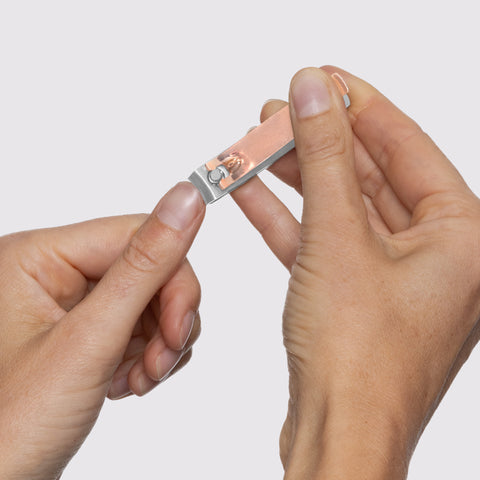 Model using Rose Gold Combo Clipper with curved blade on fingernails