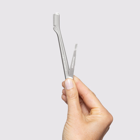 Model holding Brow Razor and Mini Tweezer Set
