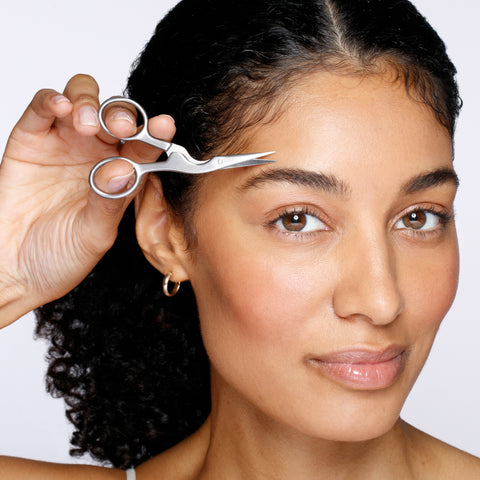 Model using stainless steel brow scissors