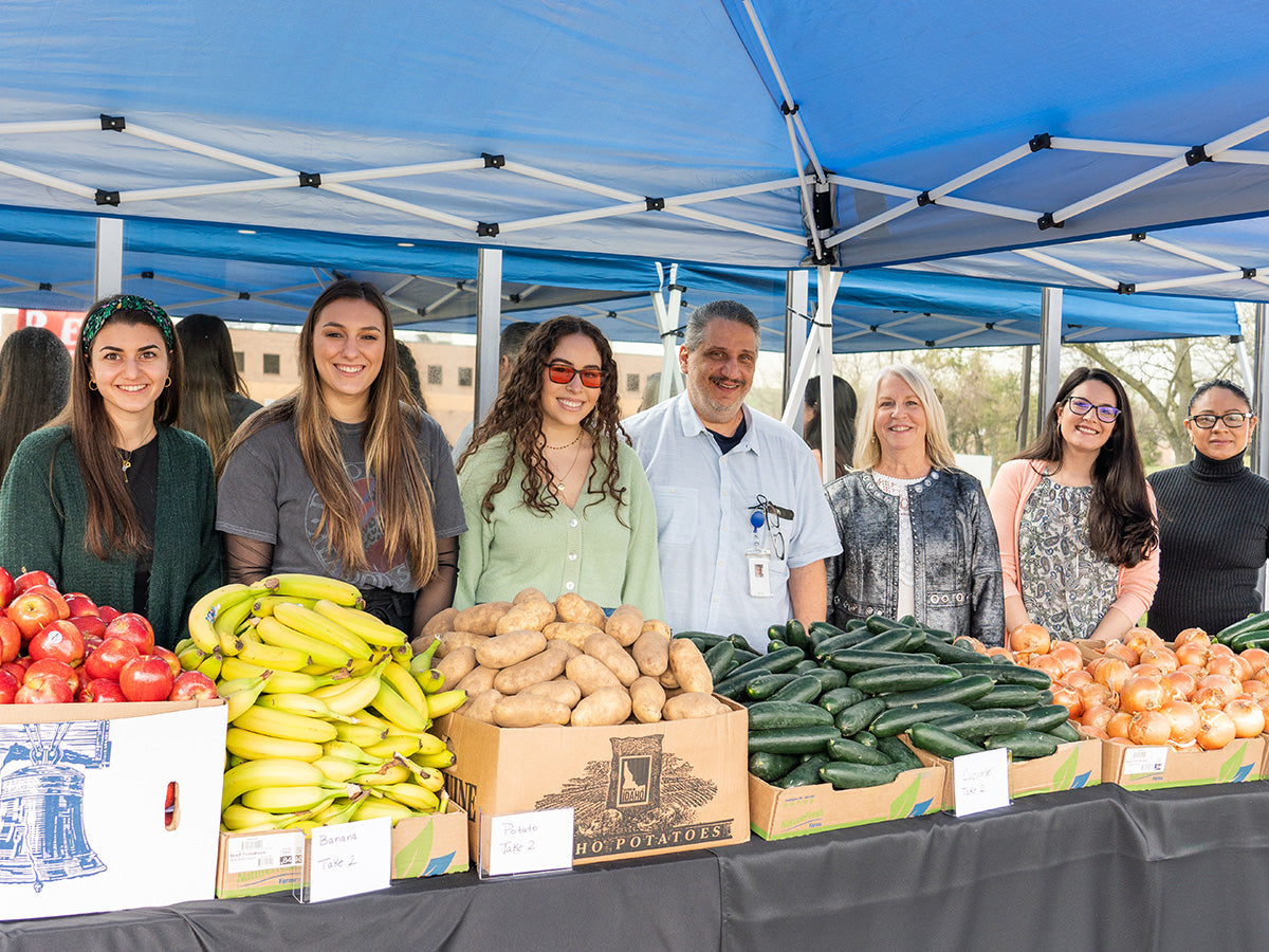 Tweezerman Team Members Portrait at  a Fresh Vegetables Market community event. 
