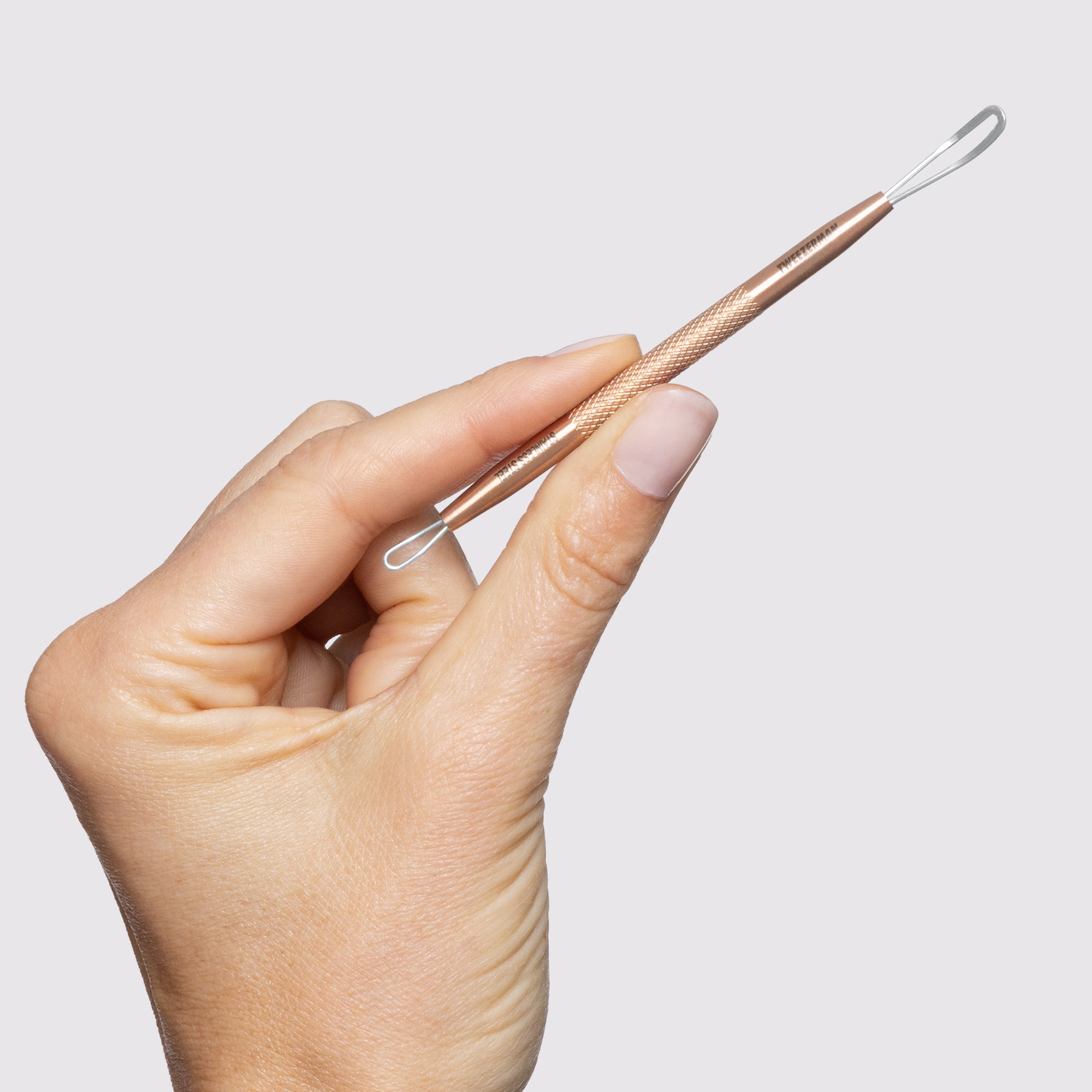 MODEL holding Rose Gold No-Slip Skincare Tool
