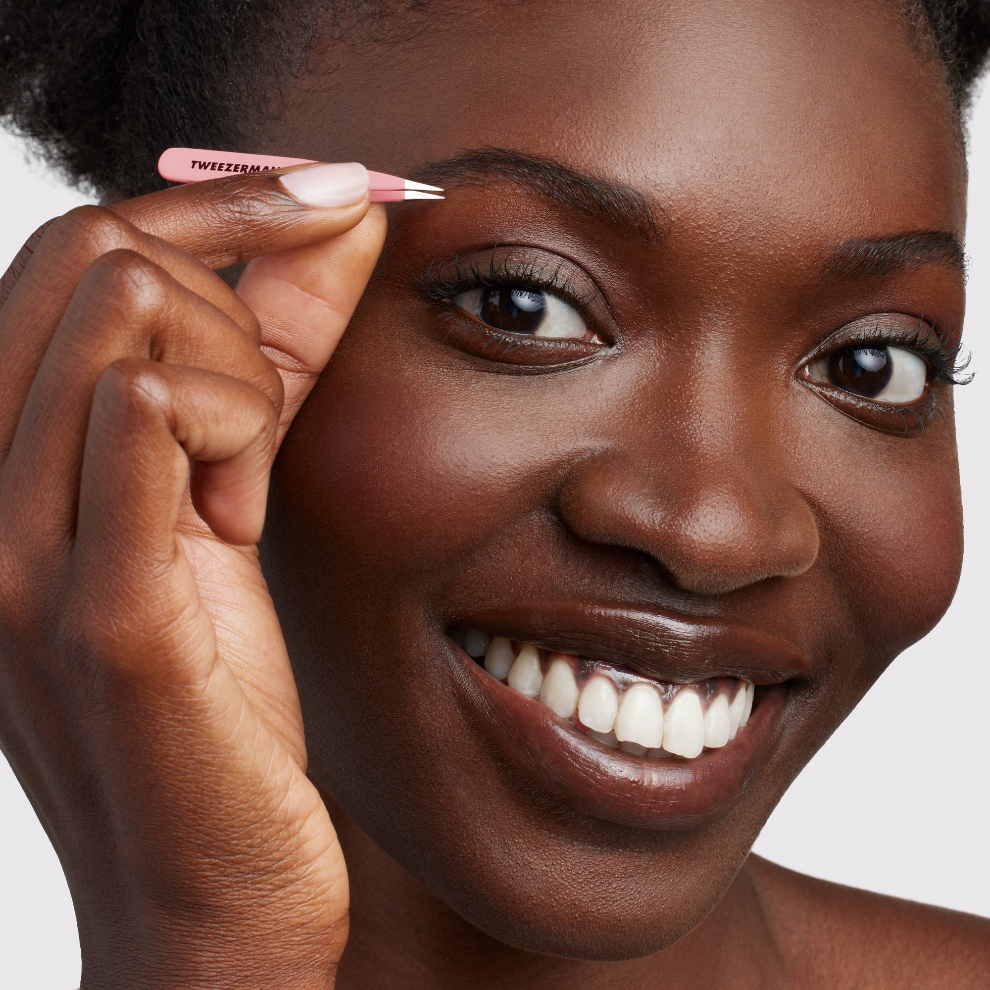 Model using pink micro mini slant tweezer